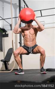Muscular Man Doing Exercise With Medicine Ball In Gym. High quality photo. Muscular Man Doing Exercise With Medicine Ball In Gym.
