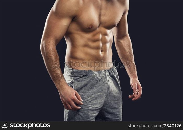 Muscular man, isolated over a gray background