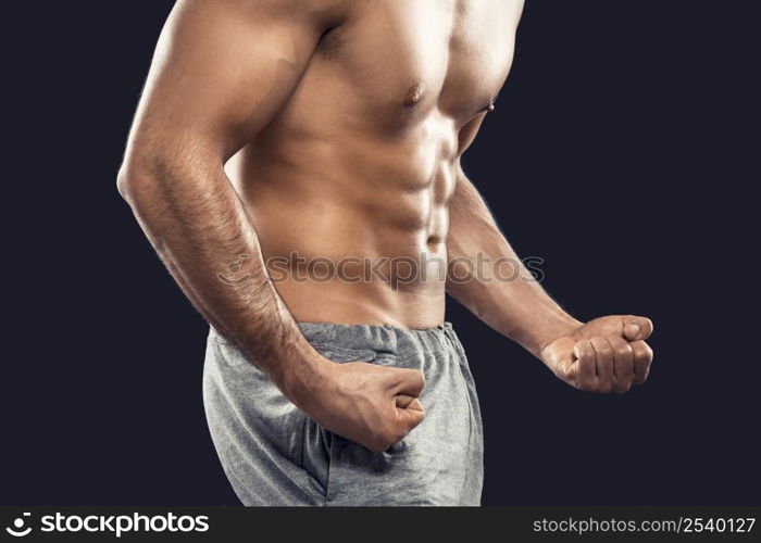 Muscular man, isolated over a gray background