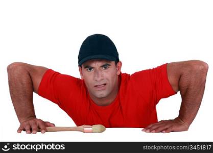 Muscular man lifting himself up onto a ledge