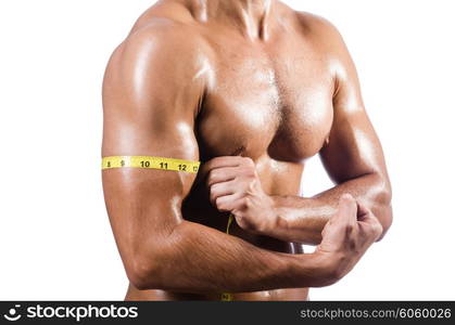 Muscular man measuring his muscles