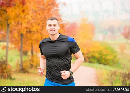 muscular man running on a footpath in the park