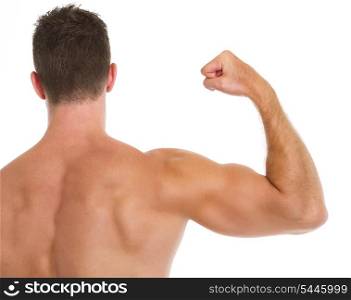Muscular man showing biceps. Rear view