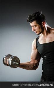 Muscular ripped bodybuilder with dumbbells