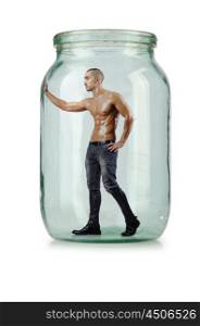 Muscular ripped man in glass jar