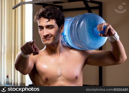 Muscular ripped man with big water bottle