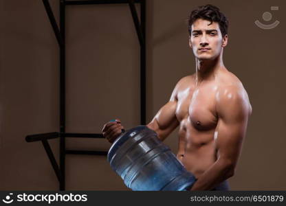 Muscular ripped man with big water bottle