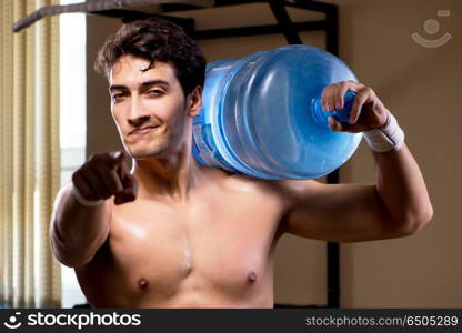 Muscular ripped man with big water bottle