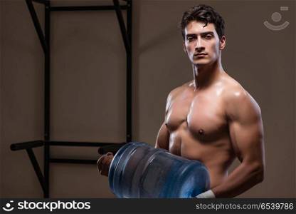 Muscular ripped man with big water bottle