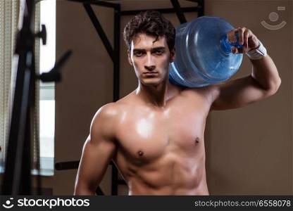 Muscular ripped man with big water bottle