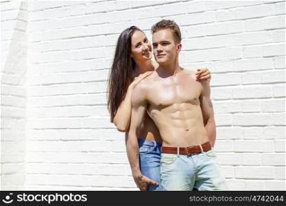 Muscular young man and sexy naked woman, summer outdoors