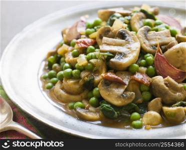 Mushroom and Pea Curry with Roasted Garlic on a Pewter Plate