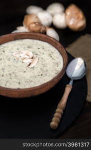 Mushroom cream soup on the table, rustic style