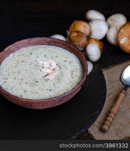 Mushroom cream soup on the table, rustic style
