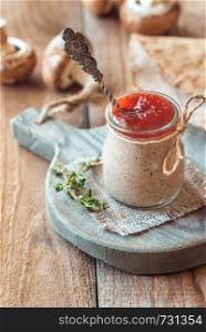 Mushroom pate decorated with with fresh thyme in the glass jar