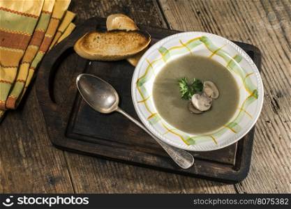 Mushroom soup on vintage wooden table