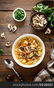 Mushroom soup with kidney bean, potato and carrot. Top view