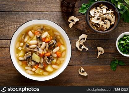 Mushroom soup with kidney bean, potato and carrot. Top view, copy space