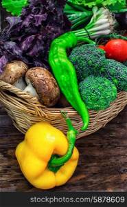 mushrooms and broccoli,leeks,lettuce, peppers in basket in rustic style.