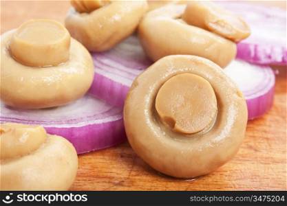 mushrooms and onions on a cutting board