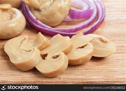 mushrooms and onions on a cutting board