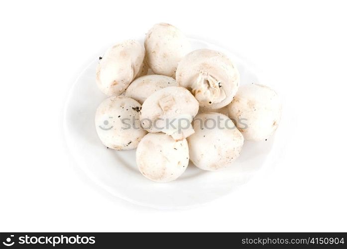 Mushrooms, champignon at plate isolated on a white background