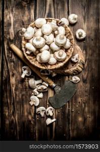 Mushrooms style background. Fresh mushrooms with a hatchet on a tree trunk. On wooden background.. Mushrooms style background