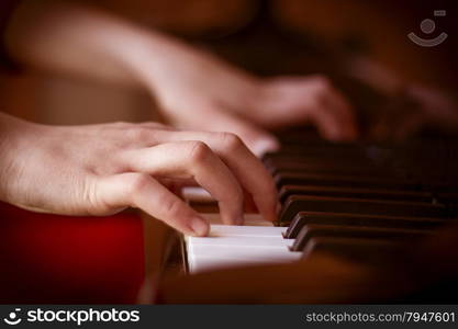 Music abstract background with hands playing on keyboard of piano