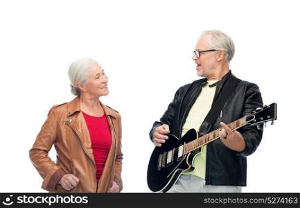 music, age and people concept - happy senior couple with electric guitar. happy senior couple with electric guitar