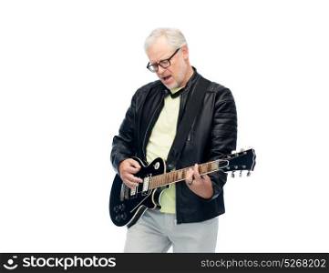 music, age and people concept - happy senior man playing electric guitar and singing. happy senior man playing electric guitar