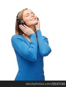 music and technology concept - smiling young woman with closed eyes listeting to music with headphones