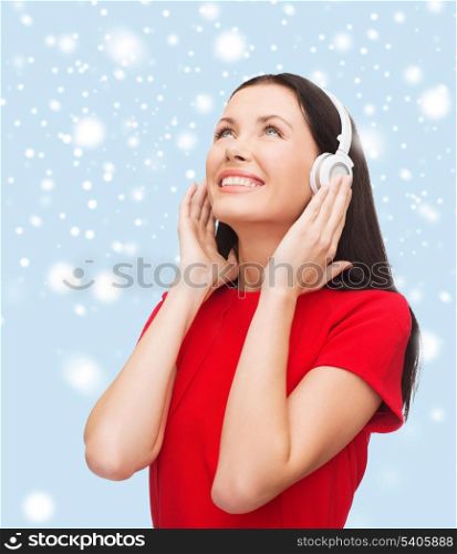 music and technology concept - smiling young woman with headphones