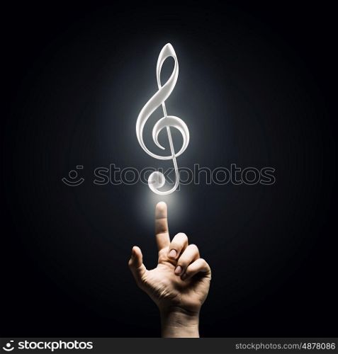 Music concept icon. Male hand pointing with finger at music sign
