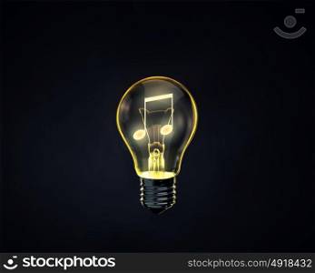 Music concept. Light bulb with music note inside on dark background