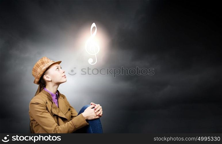 Music concept. Young pretty woman looking at music symbol