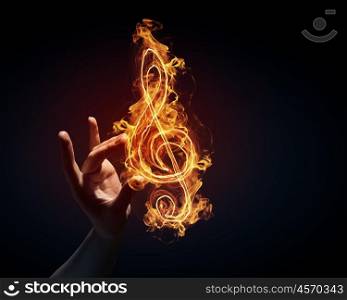 Music conceptual image. Music light glowing symbol in palm on dark background