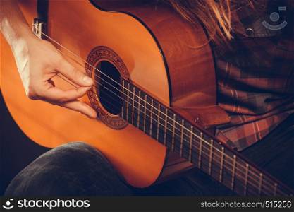 Music hobby people concept. Male hands with guitar. Musician playing the wooden instrument.. Male hands with guitar