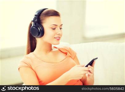 music, internet and shopping - woman with headphones and smartphone at home