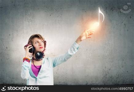 Music is my life!. Young woman wearing headphones and enjoying music