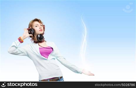 Music is my life!. Young woman wearing headphones and enjoying music