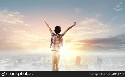 Music lover. Back view of young girl in casual enjoying music