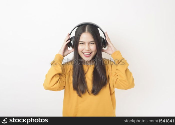 Music lover woman is enjoying with headset on white background