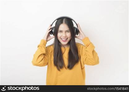 Music lover woman is enjoying with headset on white background