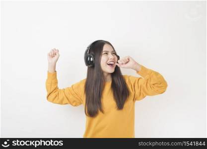 Music lover woman is enjoying with headset on white background
