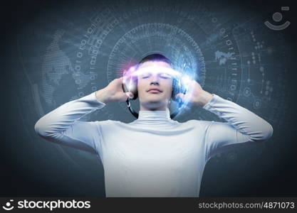 Music lover. Young man wearing headphones against media background. New technologies