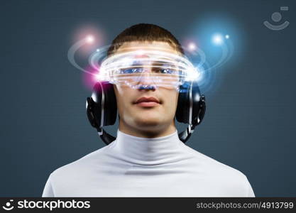 Music lover. Young man wearing headphones against media background. New technologies