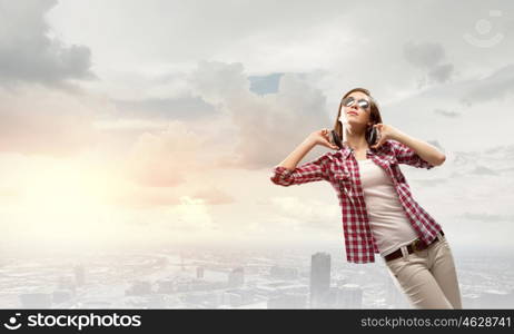 Music lover. Young pretty girl in casual with headphones listen to music