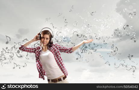 Music lover. Young pretty girl in casual with headphones listen to music