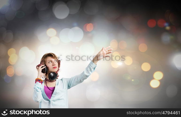 Music lover. Young pretty woman in casual wearing headphones