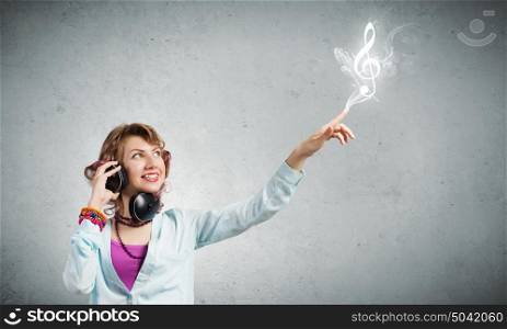 Music lover. Young pretty woman in casual wearing headphones
